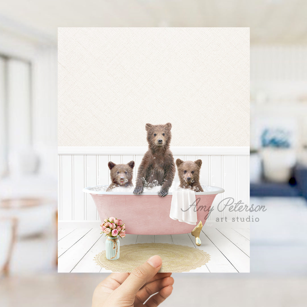 a person holding a card with three bears in a bathtub