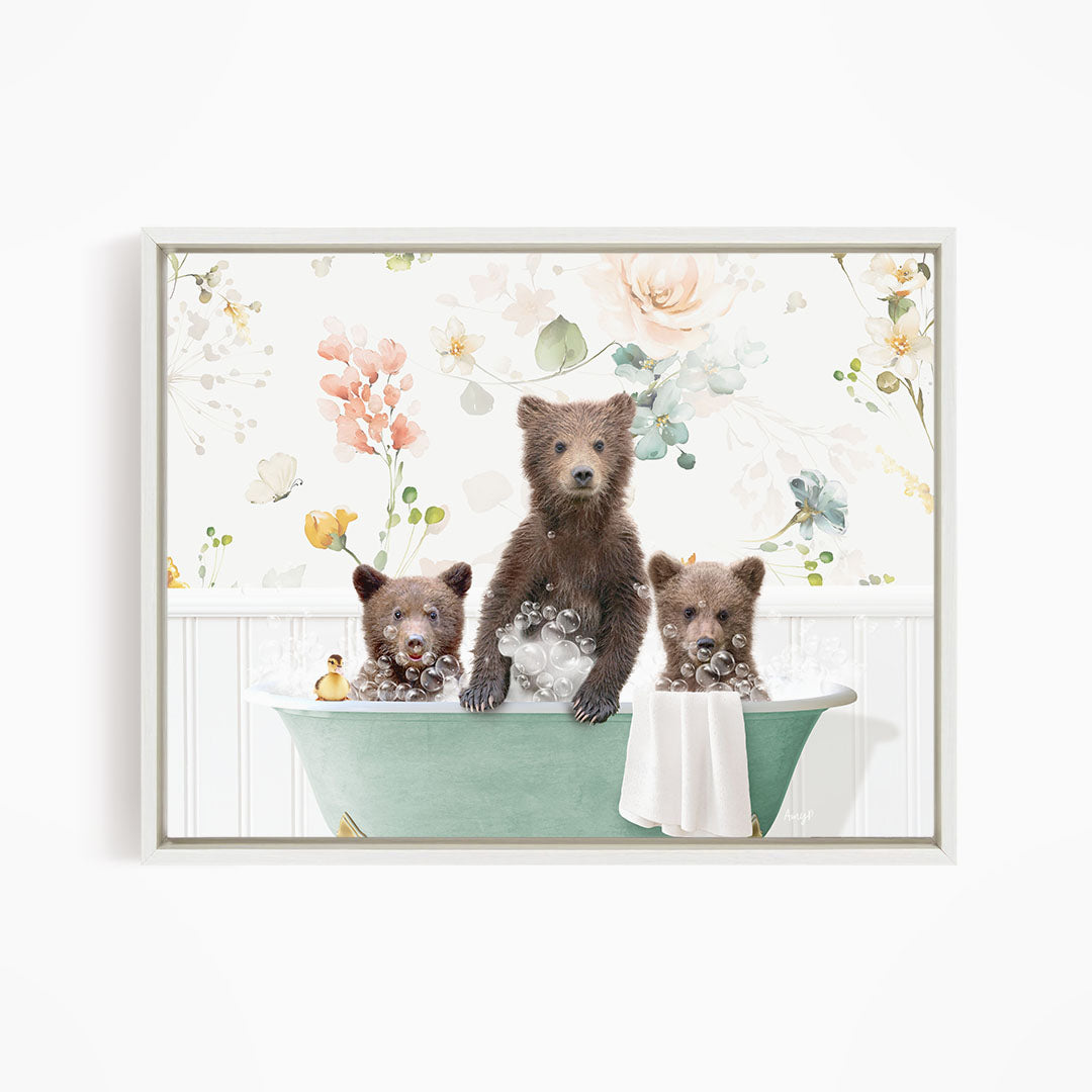 Three adorable brown bears sitting in a green bathtub, surrounded by a floral pattern.
