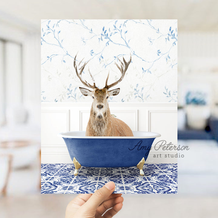 a hand holding up a card with a picture of a deer in a bathtub