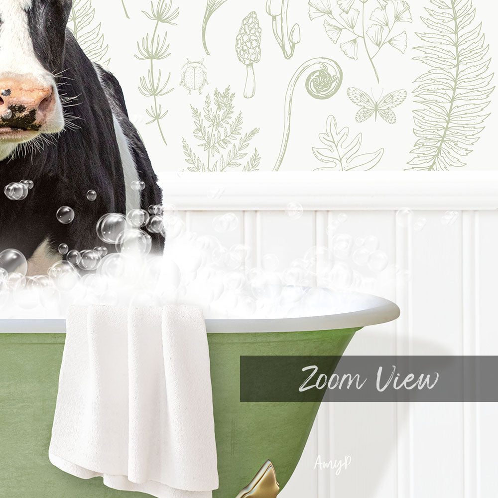 A cow is sitting in a green bathtub filled with bubbles, with a towel draped over the side of the tub.