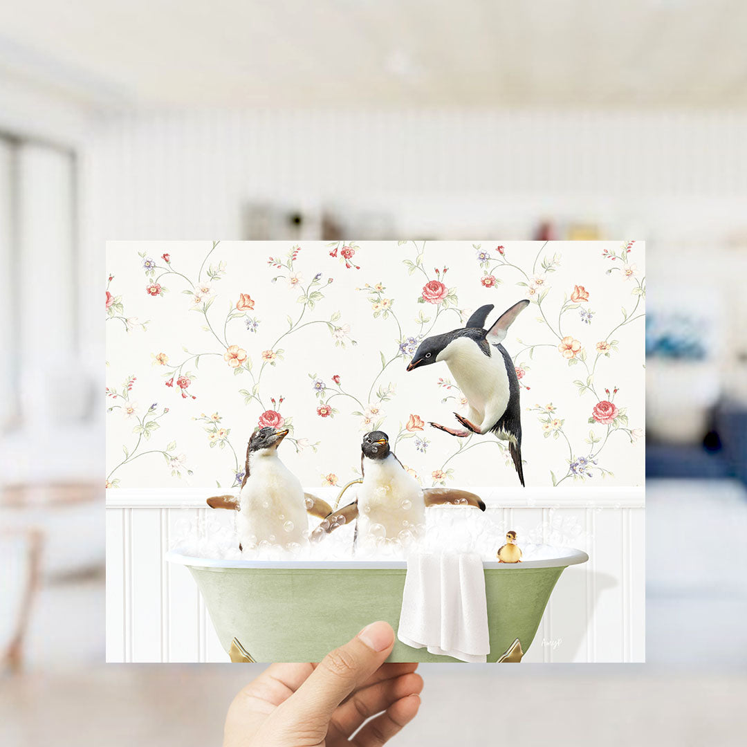 A hand holds up a collage of three images depicting penguins in a bathtub, with one penguin flying out of the tub.