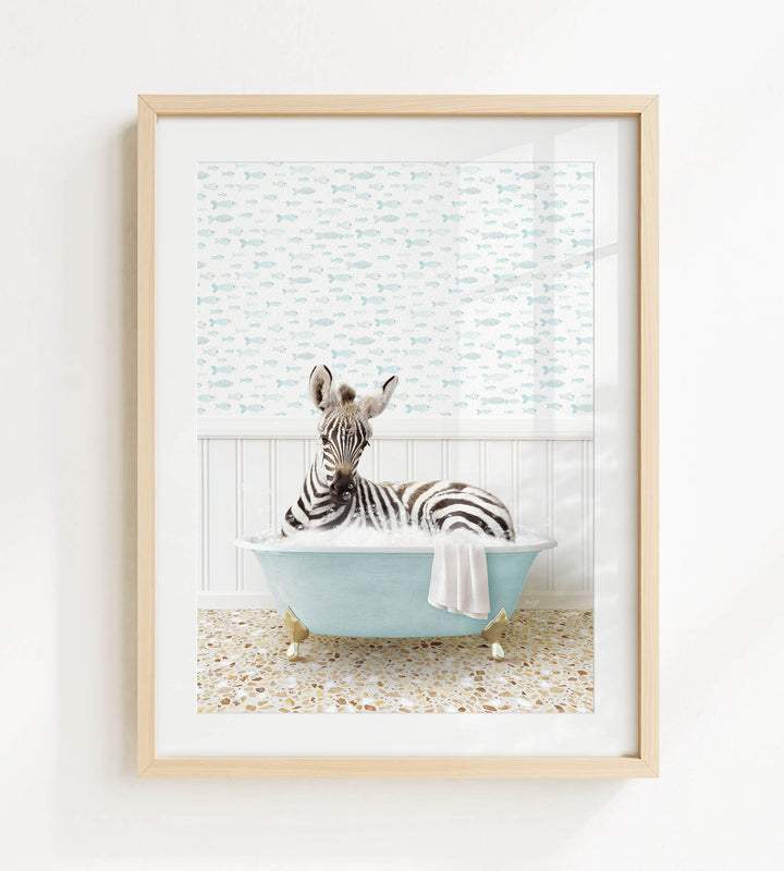 A zebra is sitting in a blue bathtub, surrounded by a patterned wall and a tiled floor.