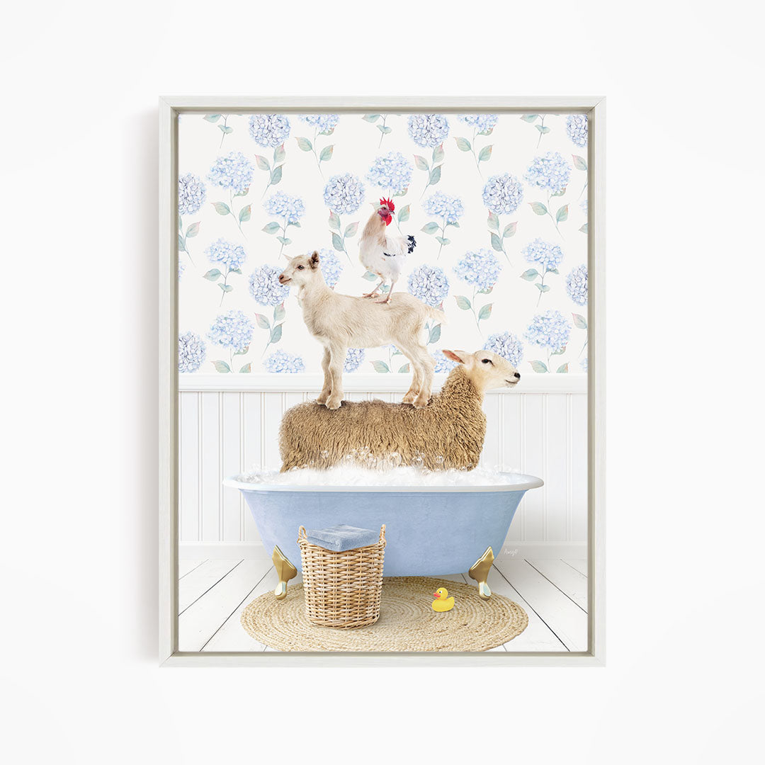 A framed image depicting a sheep standing on a tub filled with bubbles, with a chicken perched on top of it, and a yellow rubber duck floating in the water.