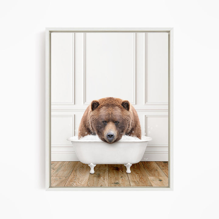 A brown bear sitting in a white bathtub filled with water, appearing to be enjoying a relaxing bath.