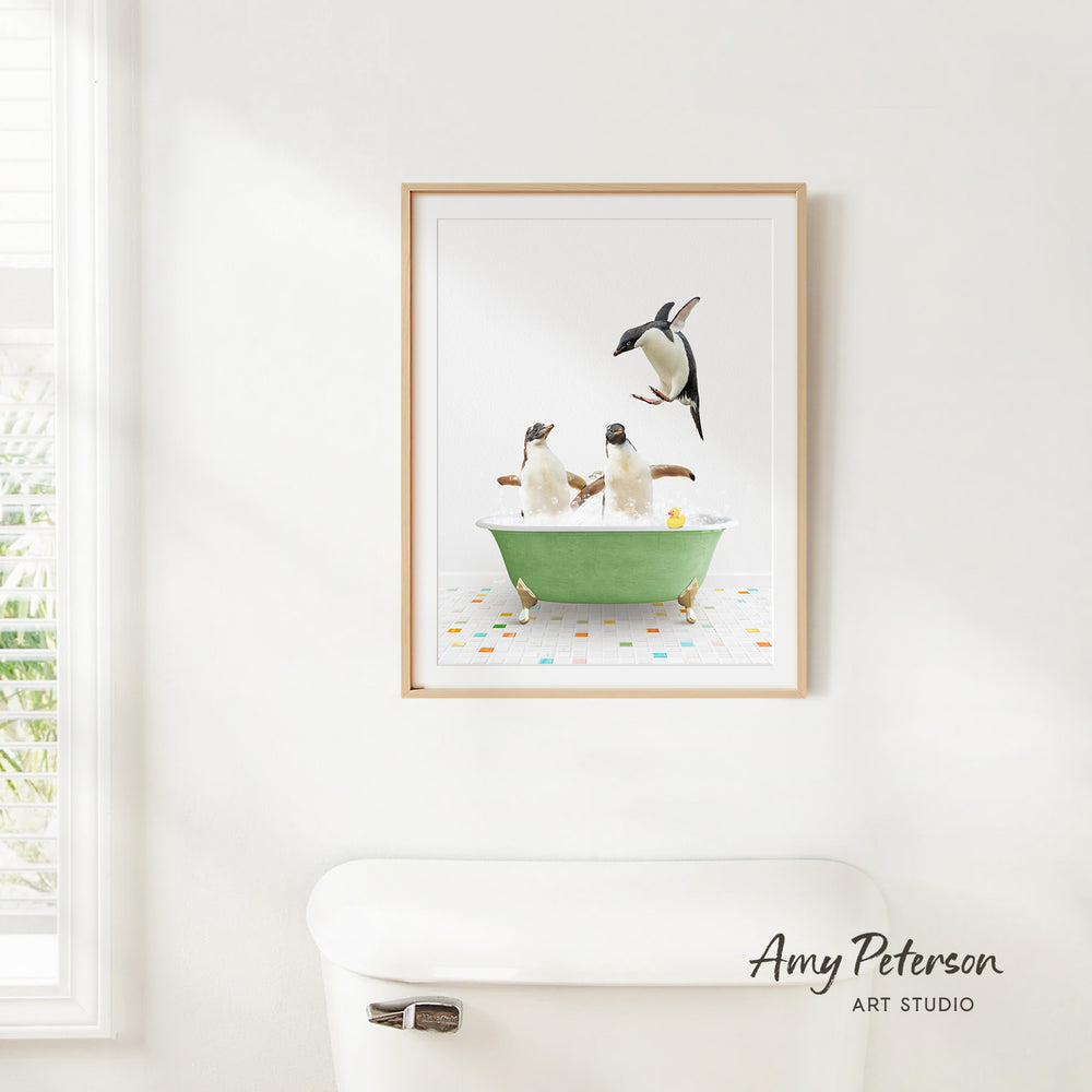 A framed image of two penguins sitting in a green bathtub, with one penguin standing on its hind legs and the other sitting comfortably.