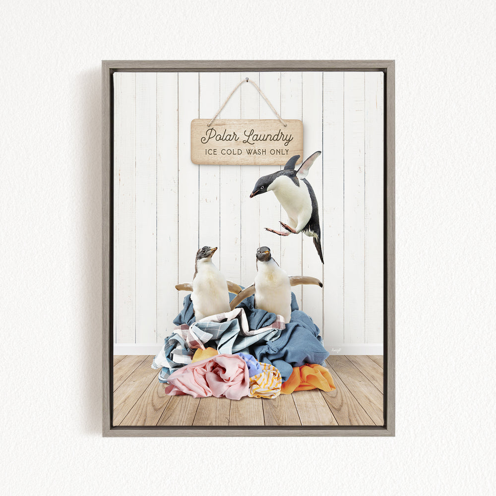 A framed image depicting three penguins on a pile of clothes, with a sign that reads "Polar Laundry Ice Cold Wash Only".