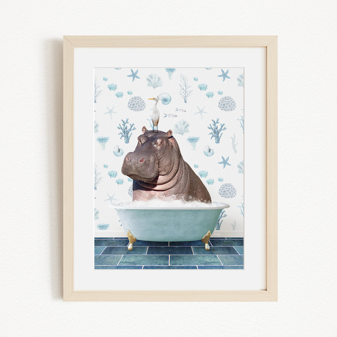 A framed image depicting a hippopotamus sitting in a bathtub, with a seagull perched on its head.
