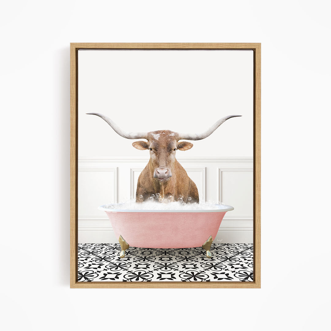 A brown bull with large horns is sitting in a pink bathtub filled with water, creating a whimsical and playful scene.