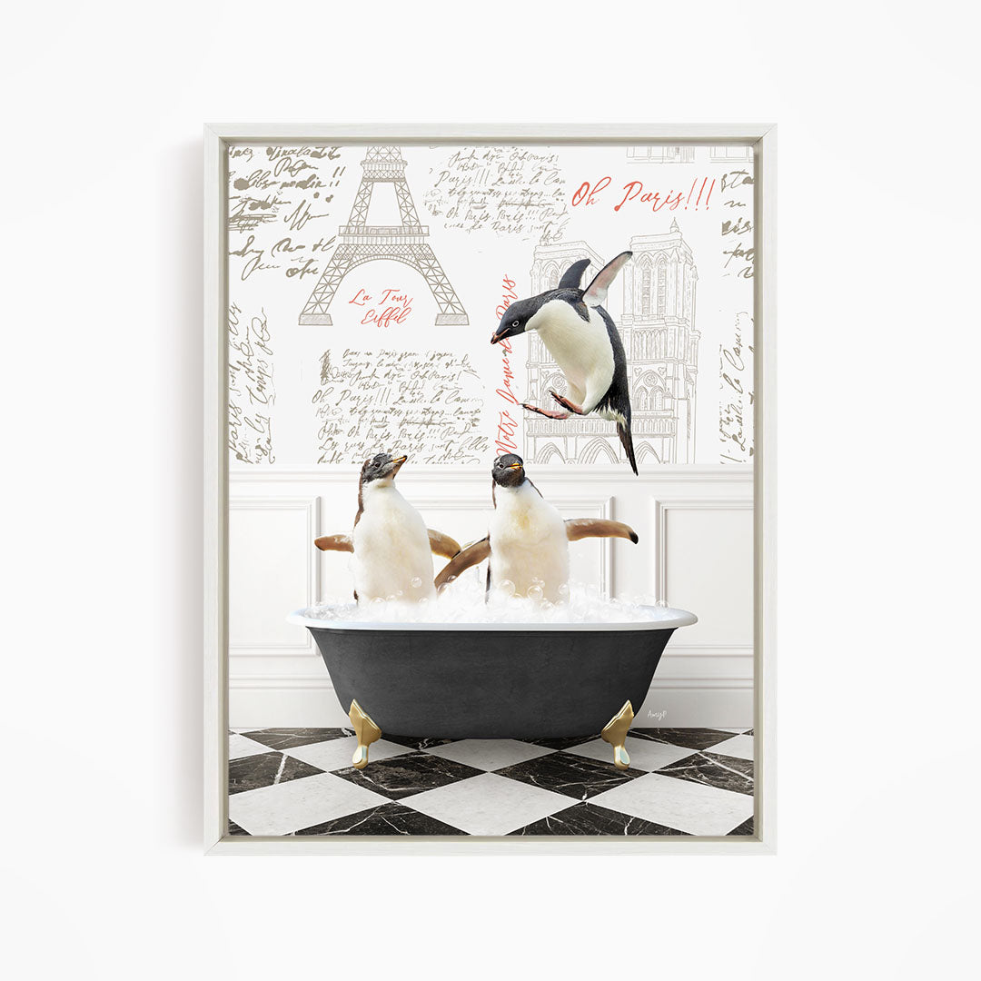 A framed image depicting three penguins sitting in a bathtub, with one penguin flying above the tub and the other two penguins sitting in the water.