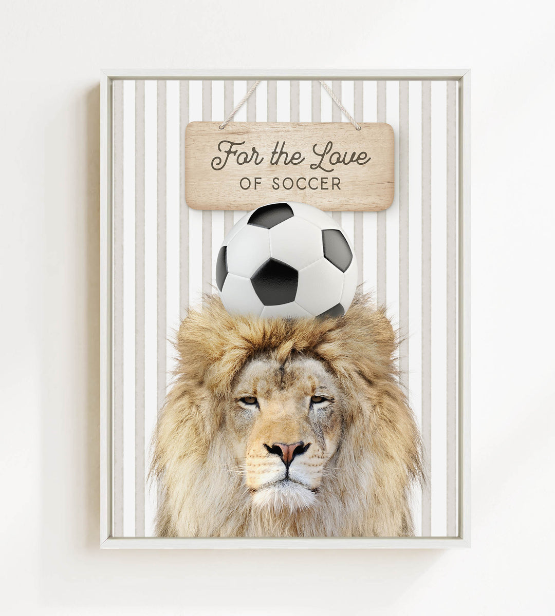 A framed image of a lion with a soccer ball on its head, accompanied by a wooden sign that reads "For the Love of Soccer".