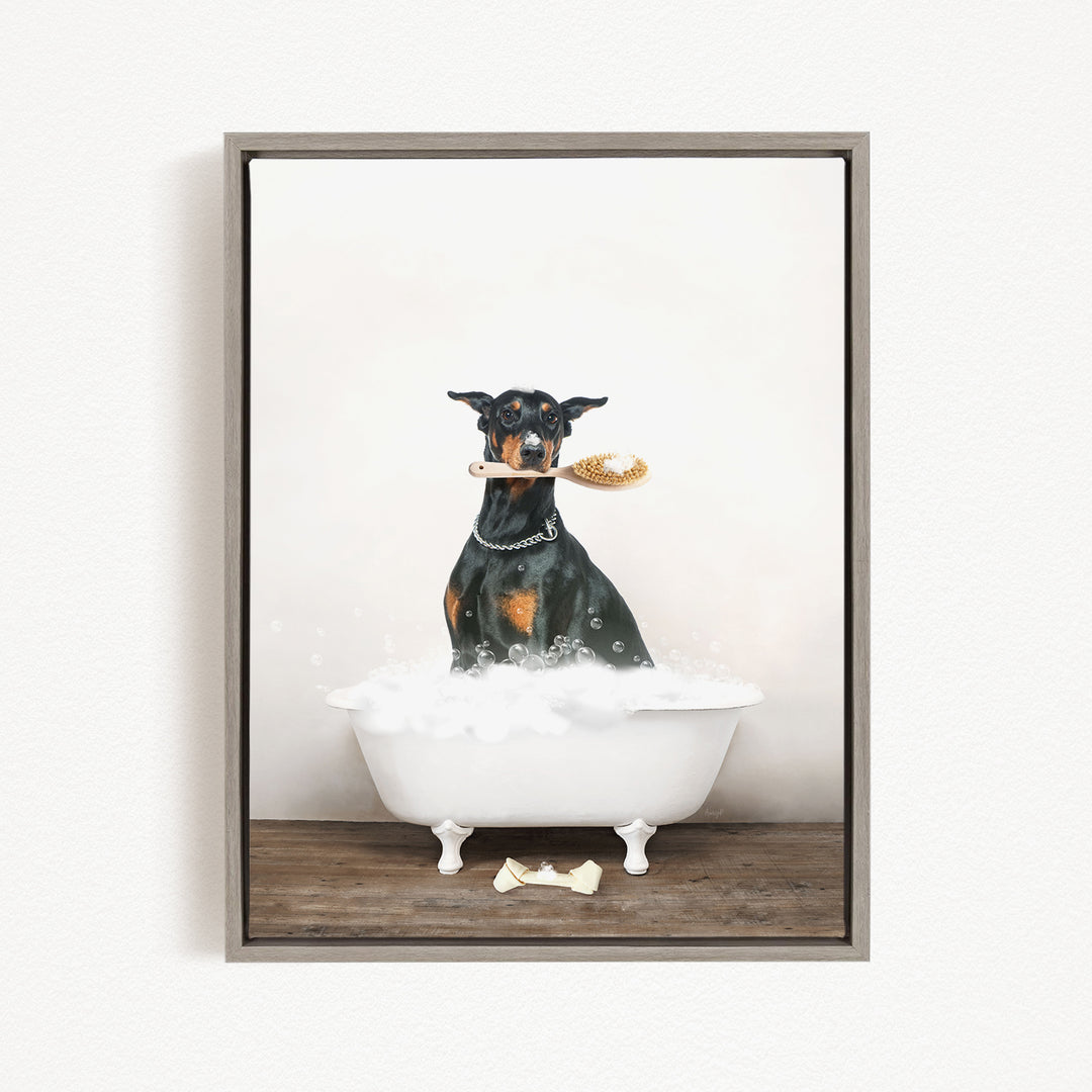 A black and brown dog sitting in a white bathtub, holding a yellow object in its mouth.