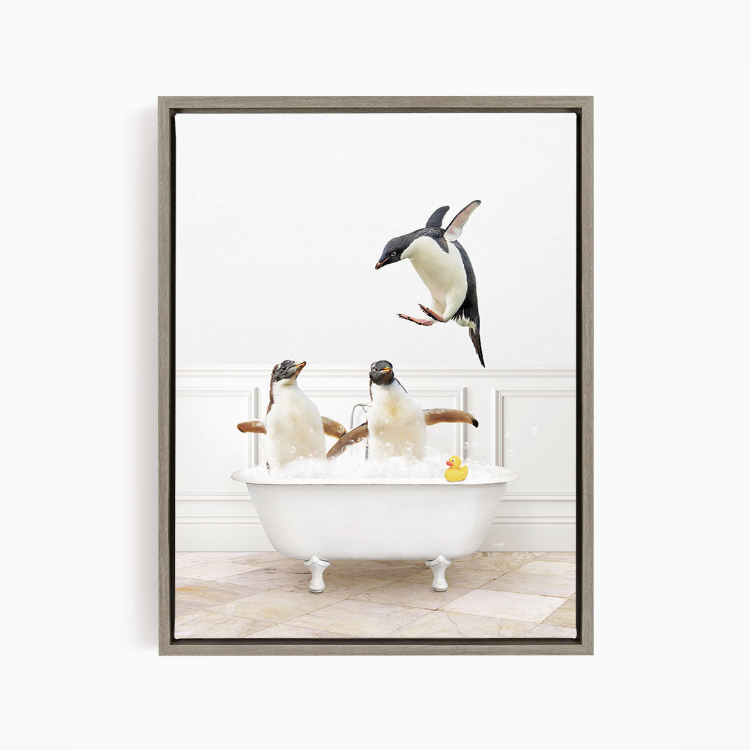 A framed image depicting three penguins sitting in a bathtub, with one penguin flying towards the others.