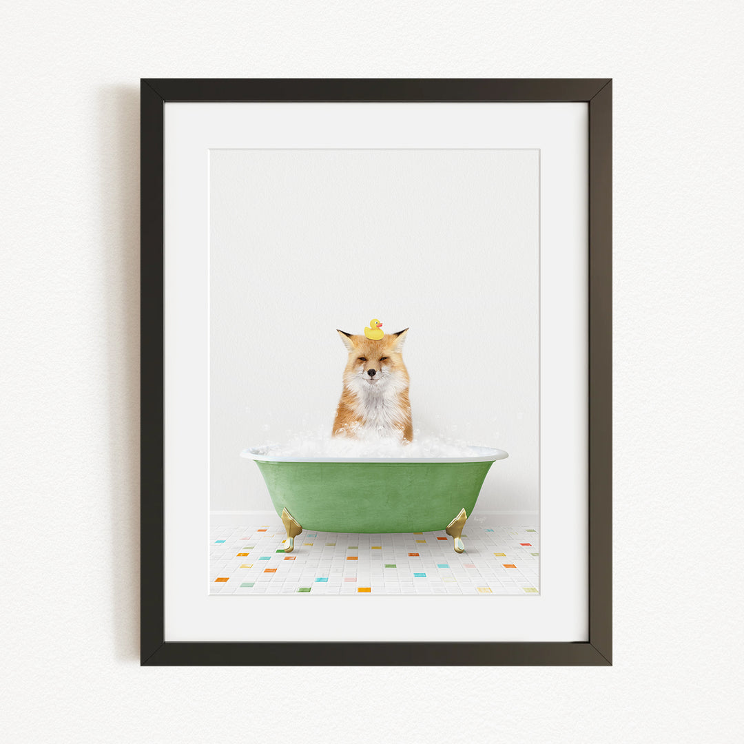 A fox is sitting in a green bathtub filled with bubbles, with a yellow rubber duck perched on its head.