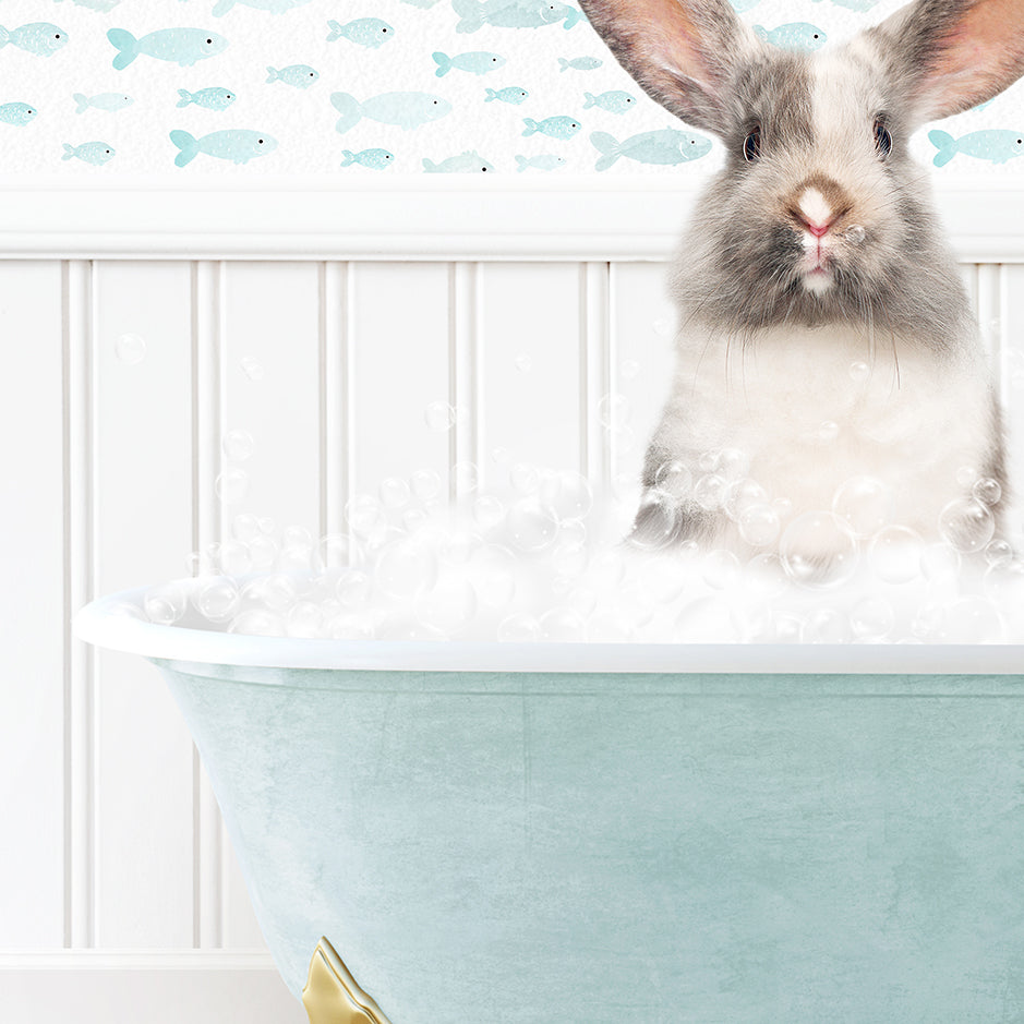 a rabbit sitting inside of a bath tub filled with bubbles