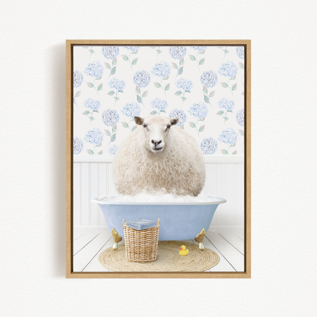 A fluffy white sheep sits in a blue bathtub filled with water, surrounded by a wicker basket and two rubber duckies.
