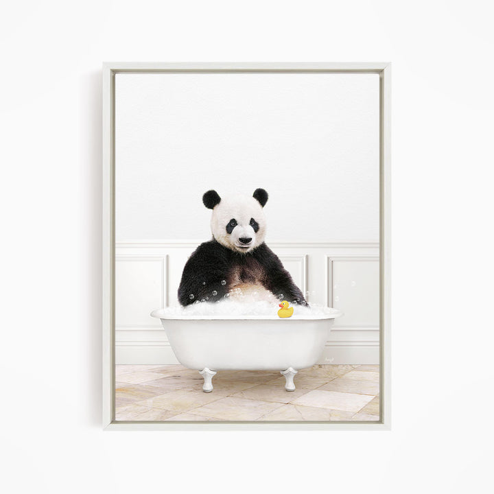 A panda bear sitting in a white bathtub, surrounded by bubbles and a rubber duck.