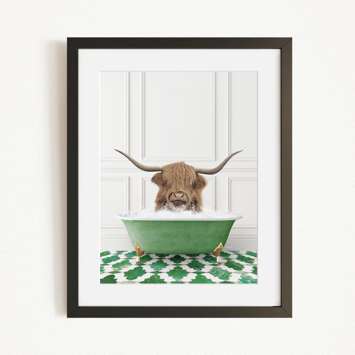 A framed image depicting a Highland cow with large horns sitting in a green bathtub filled with water, surrounded by a green and white patterned rug.