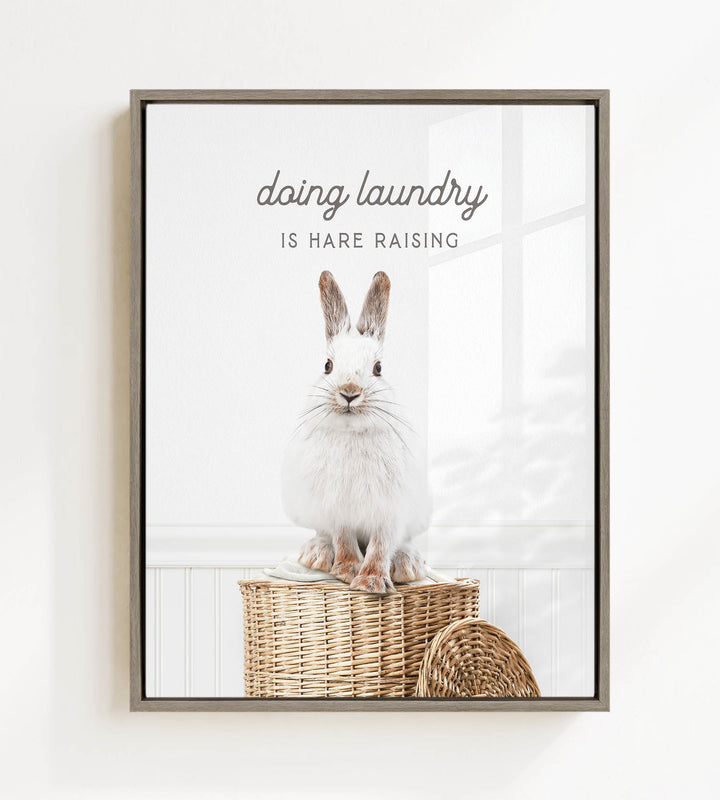A white rabbit sitting on a woven basket, with the text "Doing laundry is Hare raising" displayed above the image.