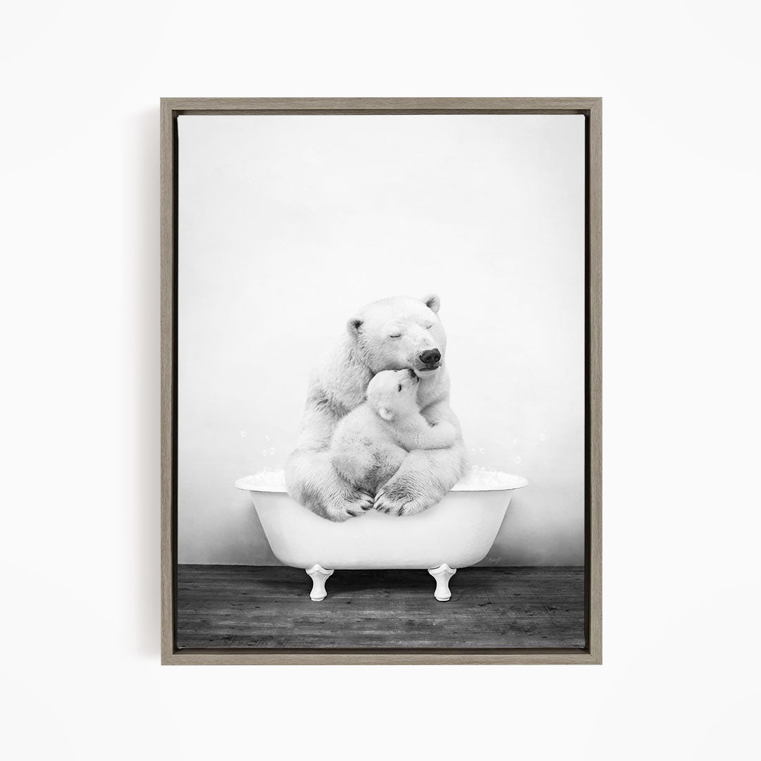 A black and white image of a mother polar bear sitting in a bathtub, with her cub resting on her lap.