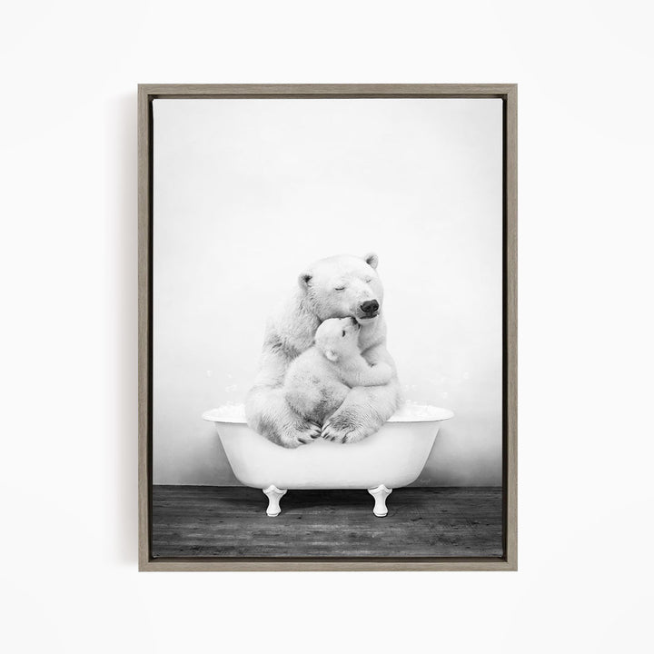 A black and white image of a mother polar bear sitting in a bathtub, with her cub resting on her lap.