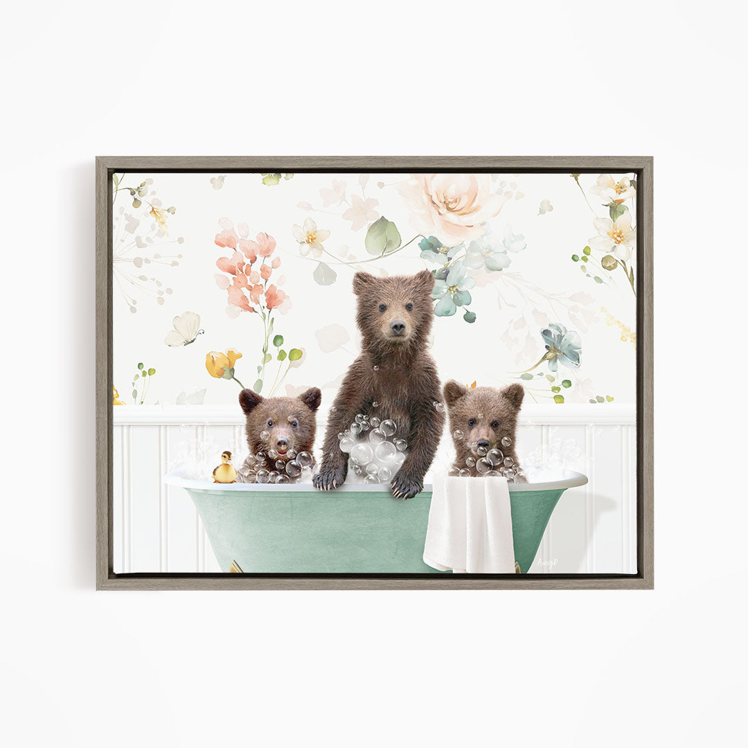 A framed image depicting three bears sitting in a green bathtub, surrounded by a floral pattern.