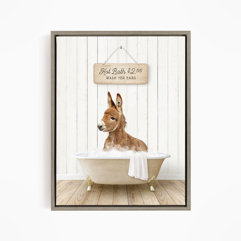 A donkey is sitting in a bathtub filled with water, with a sign above it that reads "Hot Bath $2.00 Wash Your Ears".