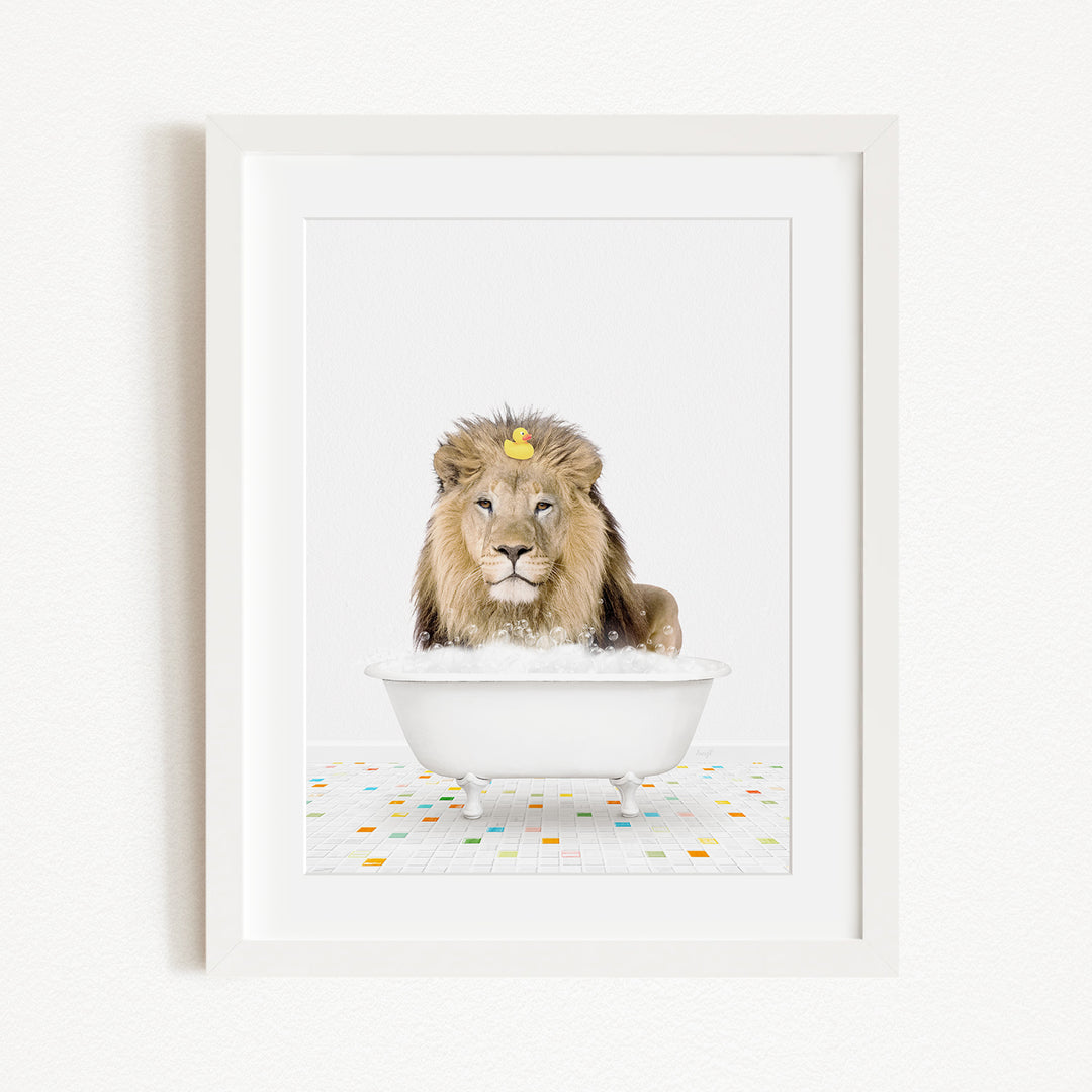 A lion sitting in a white bathtub filled with bubbles, with a yellow rubber duck floating on the water.