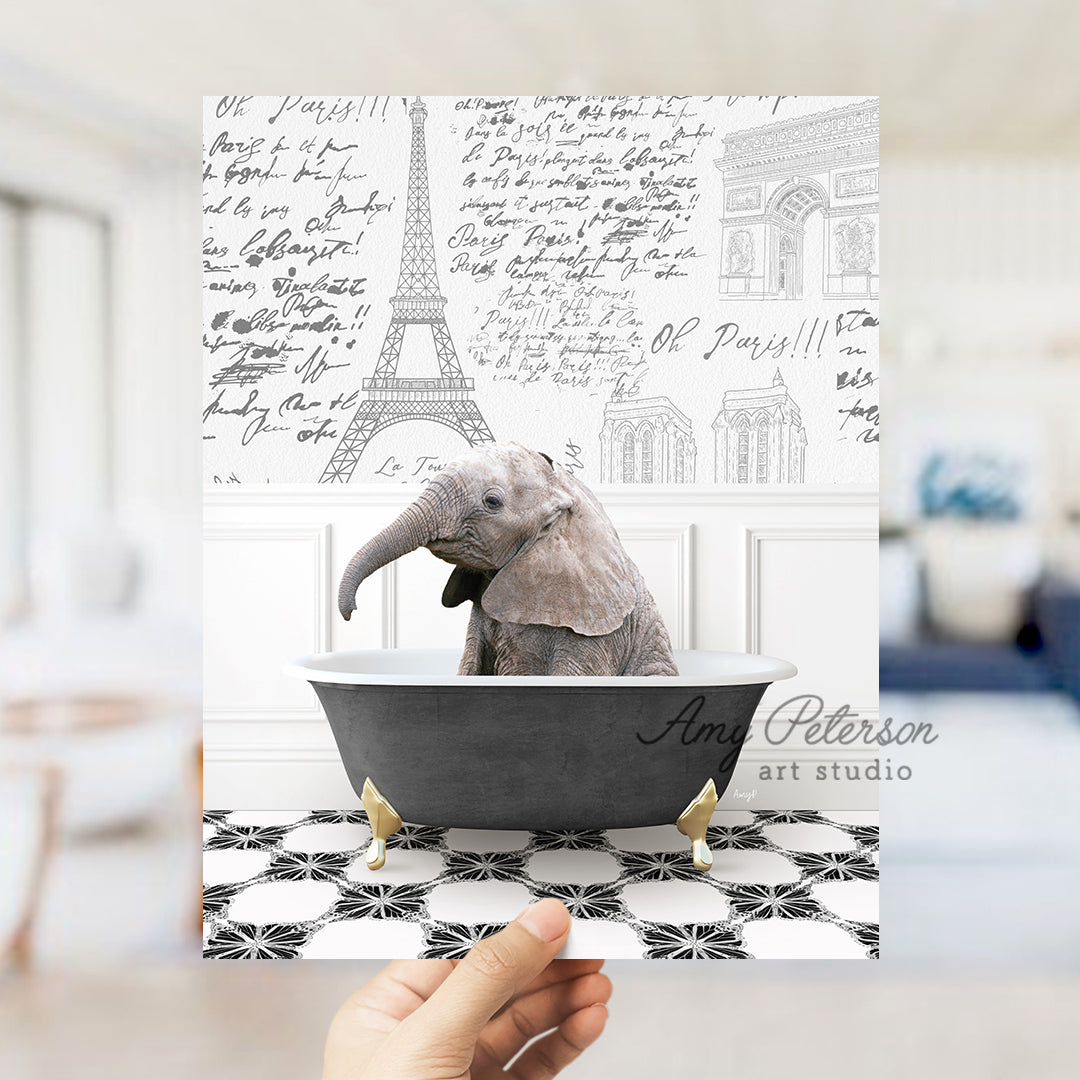 a person holding up a card with a picture of an elephant in a bathtub