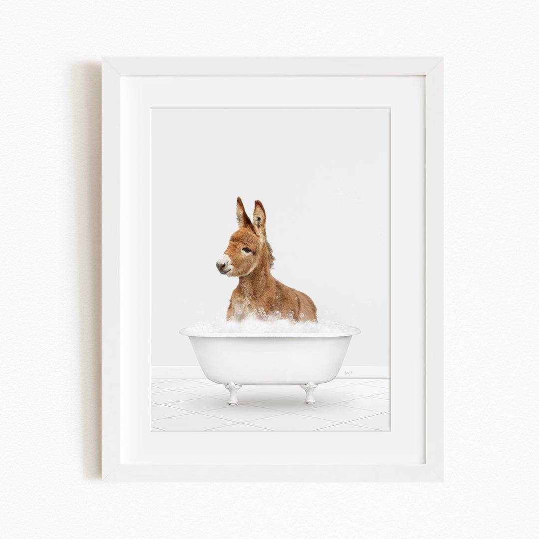 A donkey is sitting in a white bathtub filled with water, creating a playful and whimsical scene.