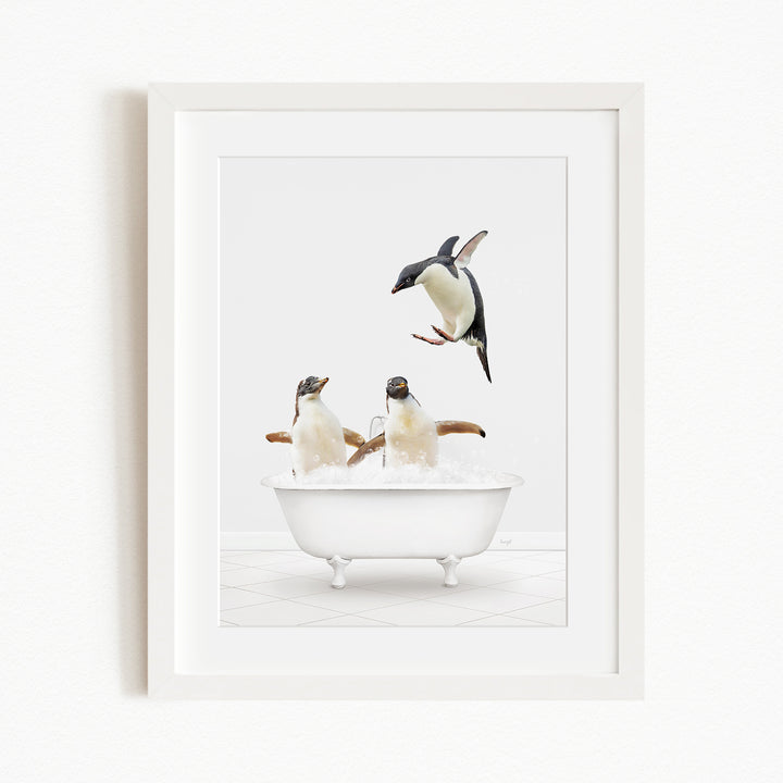 A framed image depicting two penguins sitting in a bathtub, with one penguin flying towards the other penguin.