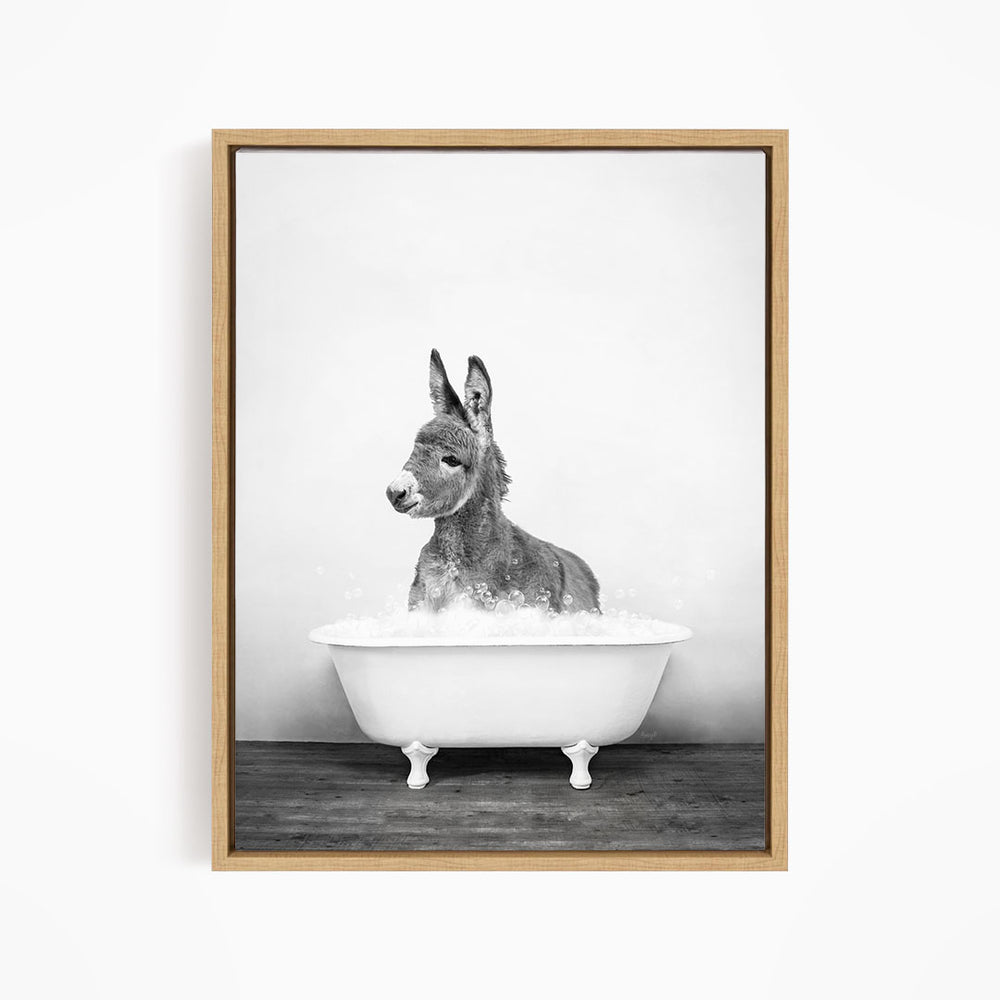 A donkey is sitting in a bathtub filled with water, creating a whimsical and playful scene.