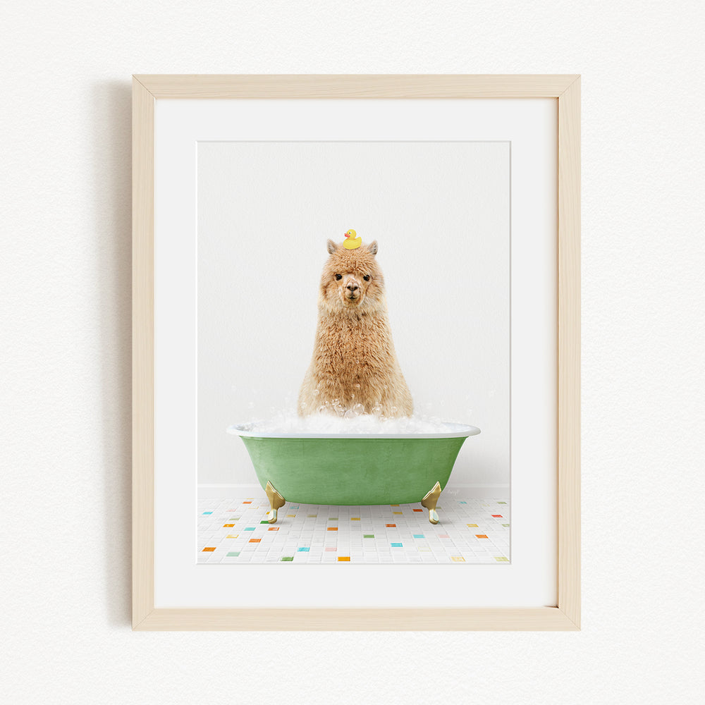 A fluffy alpaca sits in a green bathtub filled with bubbles, wearing a yellow crown and surrounded by colorful tiles on the floor.