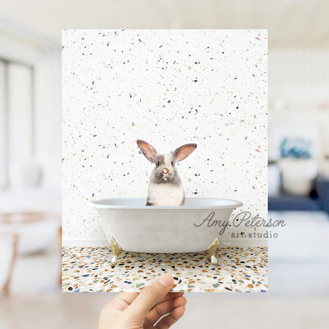 a person holding up a card with a picture of a rabbit in a bathtub