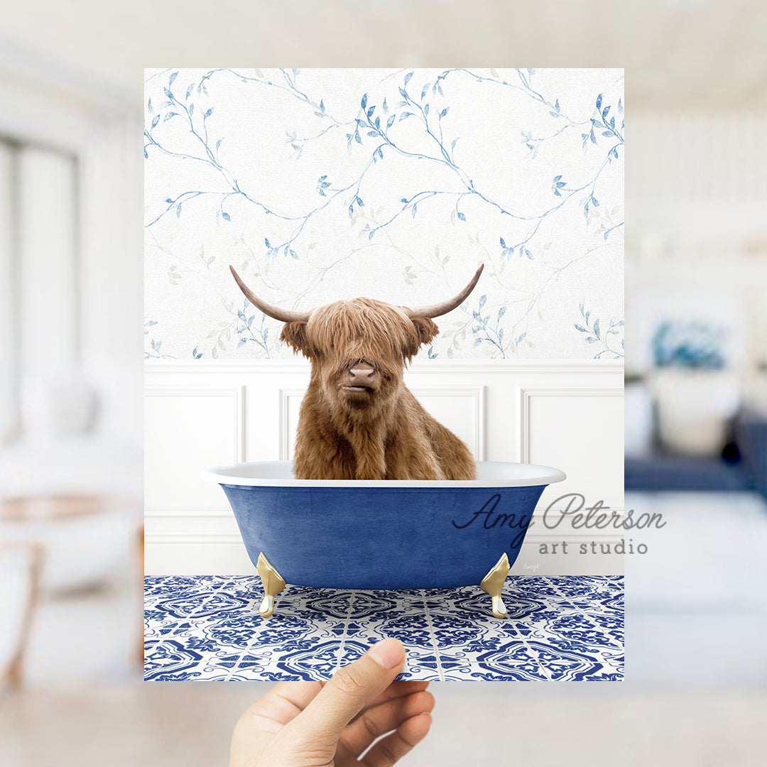 a hand holding a card with a picture of a bull in a bathtub