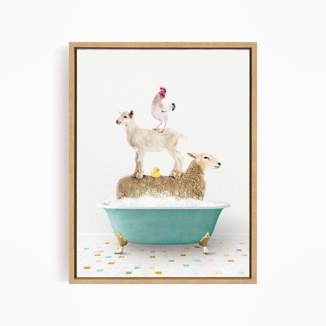 A framed image depicting a sheep standing on a goat's back while a chicken stands on top of a sheep in a bathtub filled with bubbles.