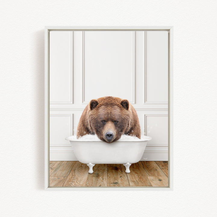 A brown bear is sitting in a white bathtub, appearing to be enjoying a relaxing bath.