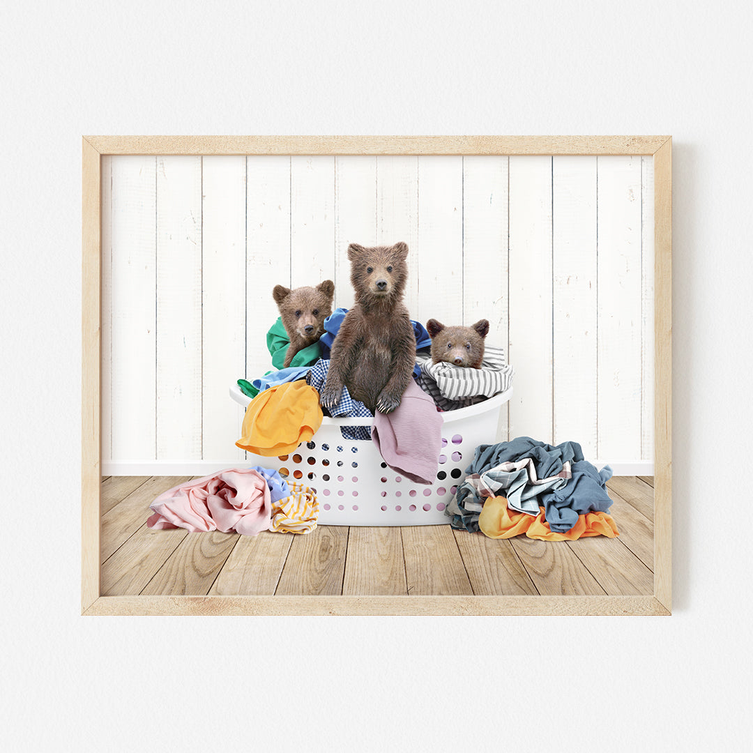 three teddy bears sitting in a laundry basket