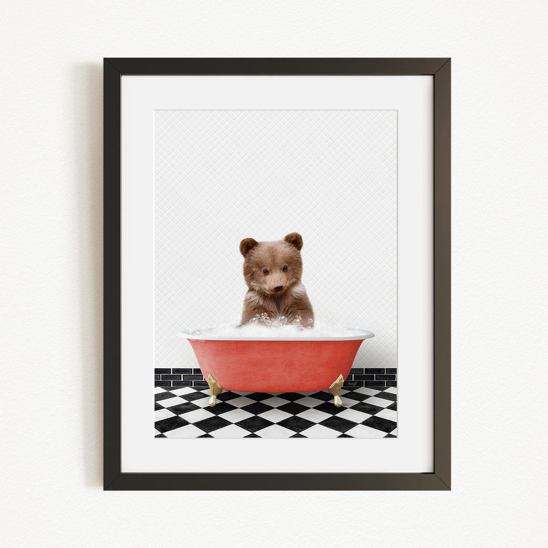 A small brown bear sitting in a red bathtub filled with water, surrounded by a black and white checkered floor.