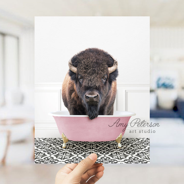 a person holding a card with a picture of a bison in a bathtub