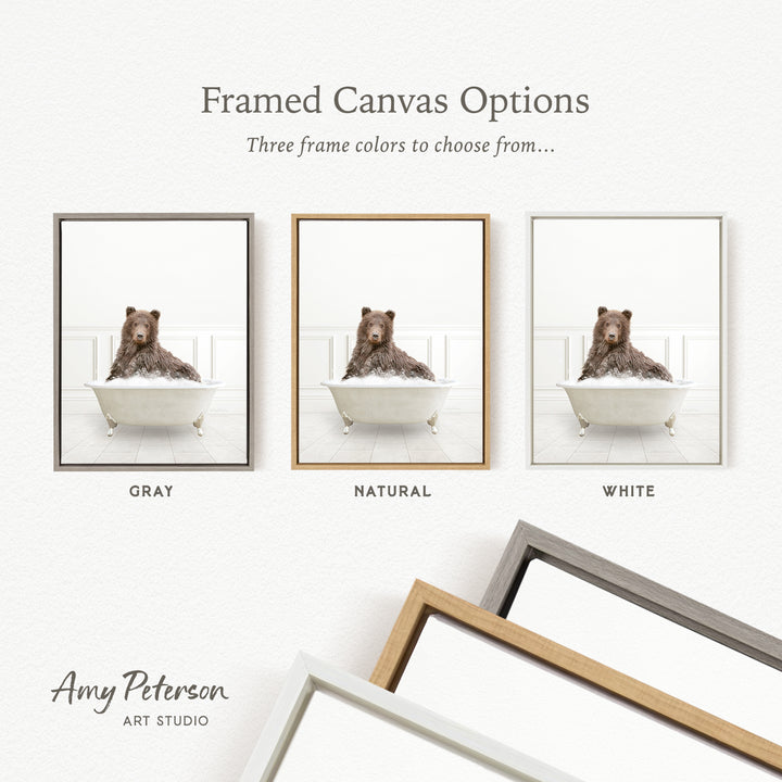 three framed canvas options, each featuring a brown bear sitting in a bathtub. The options include a gray frame, a natural frame, and a white frame.