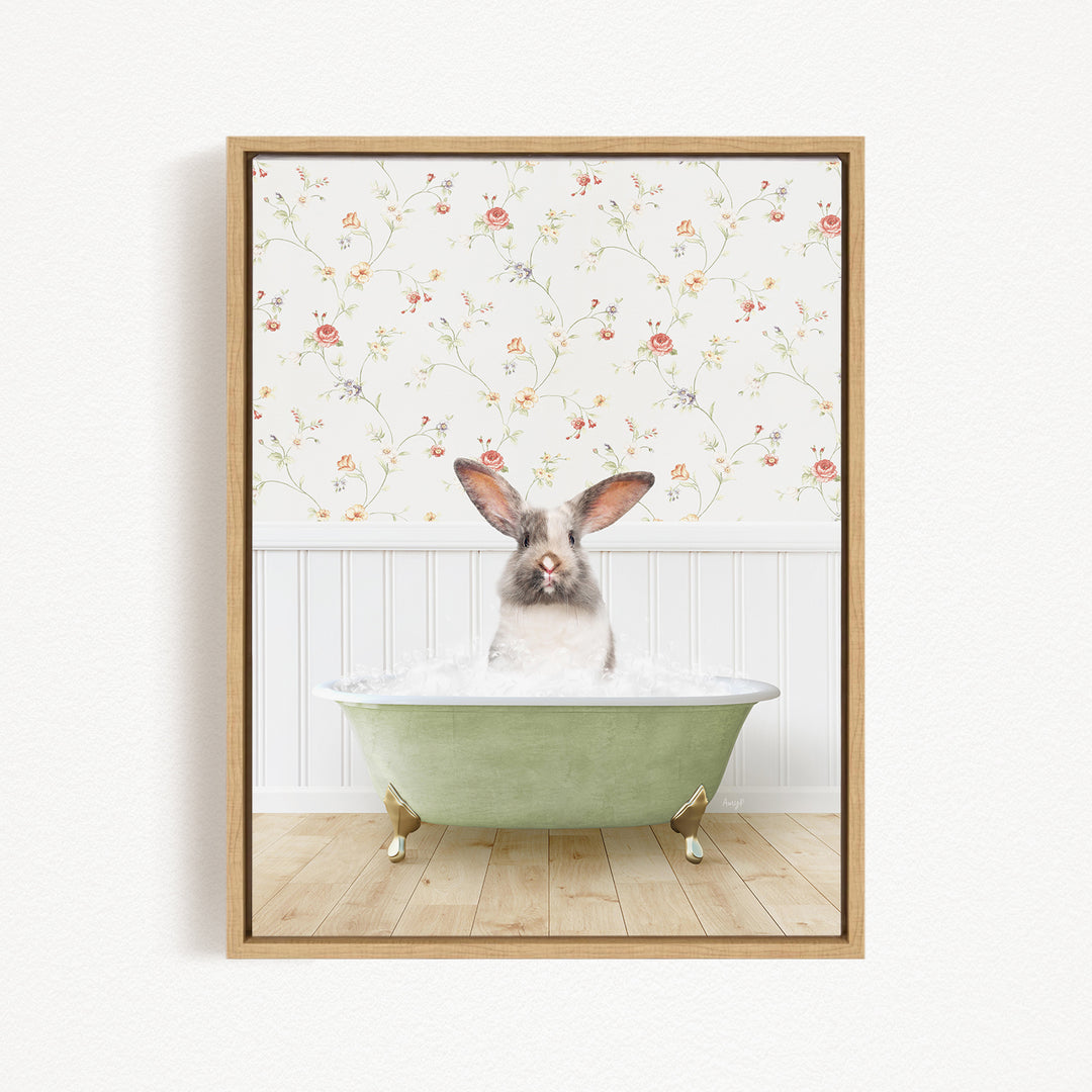 A white rabbit with brown ears is sitting in a green bathtub filled with water, with a floral wallpaper in the background.