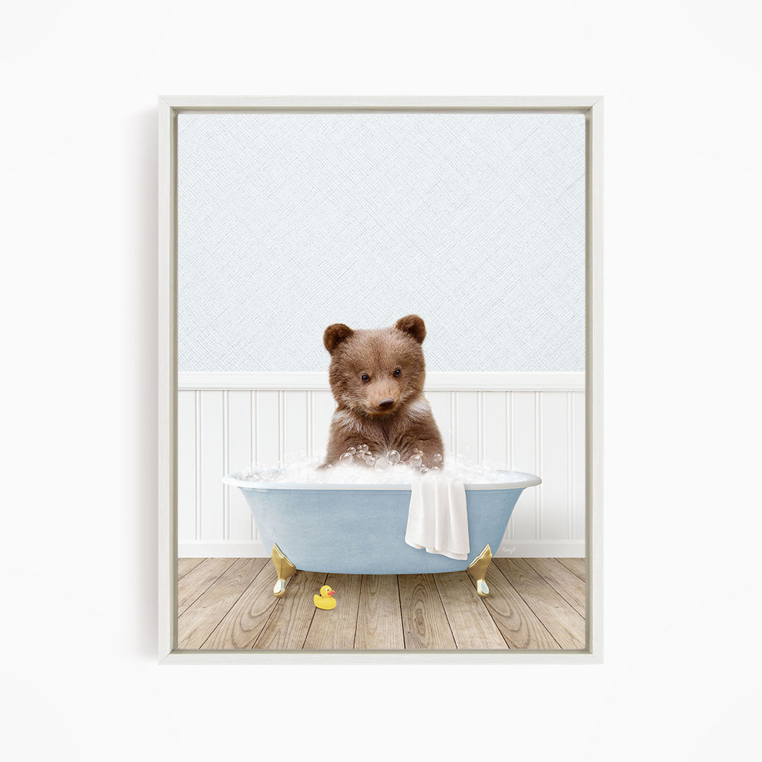 A brown bear sitting in a blue bathtub filled with water, surrounded by rubber duckies.