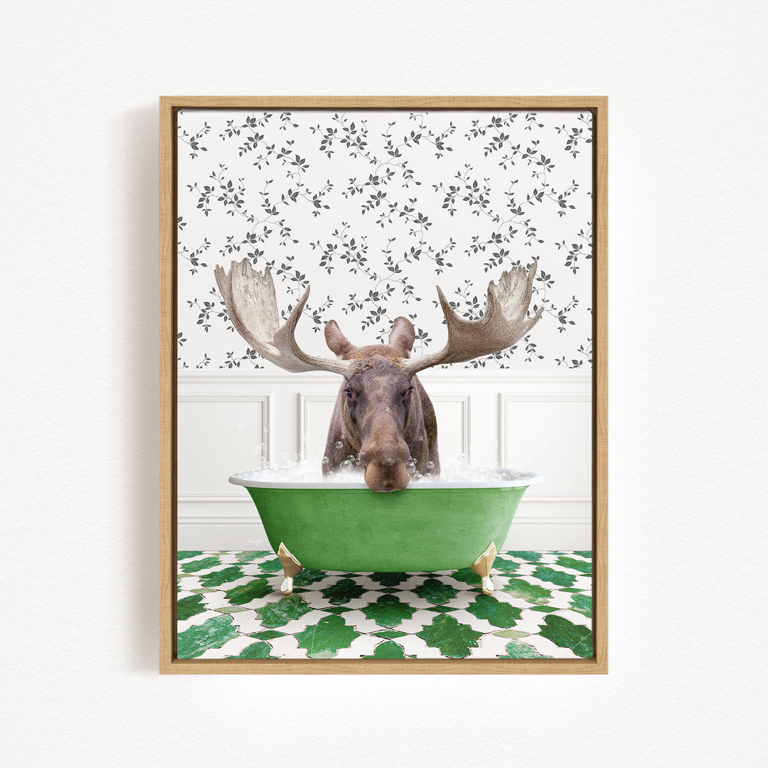 A moose with large antlers is sitting in a green bathtub filled with water, surrounded by a patterned wall and green and white tiles on the floor.