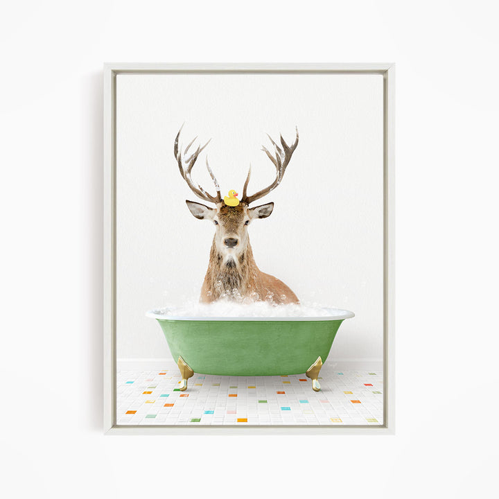 A deer with antlers is sitting in a green bathtub filled with bubbles, with a rubber duck floating on its head.