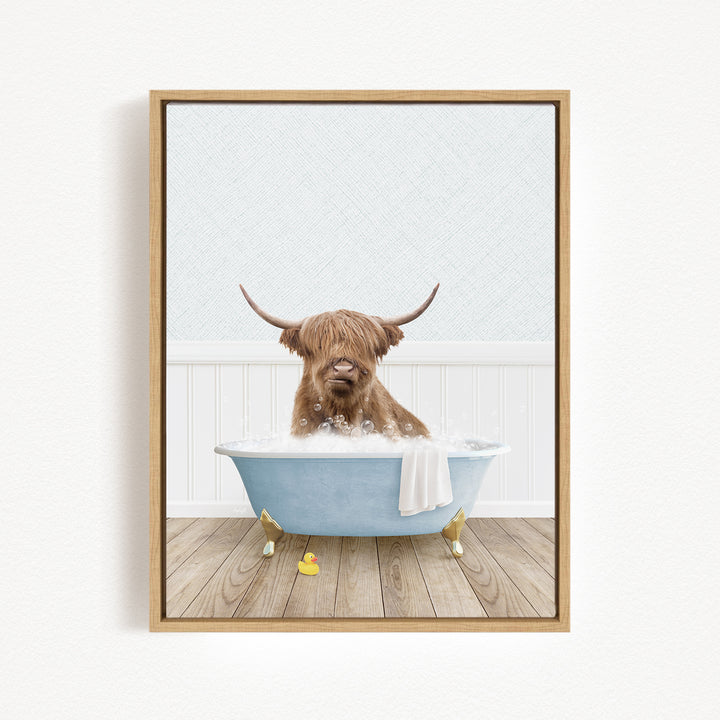 A brown cow with long horns is sitting in a blue bathtub filled with water, surrounded by rubber ducks.