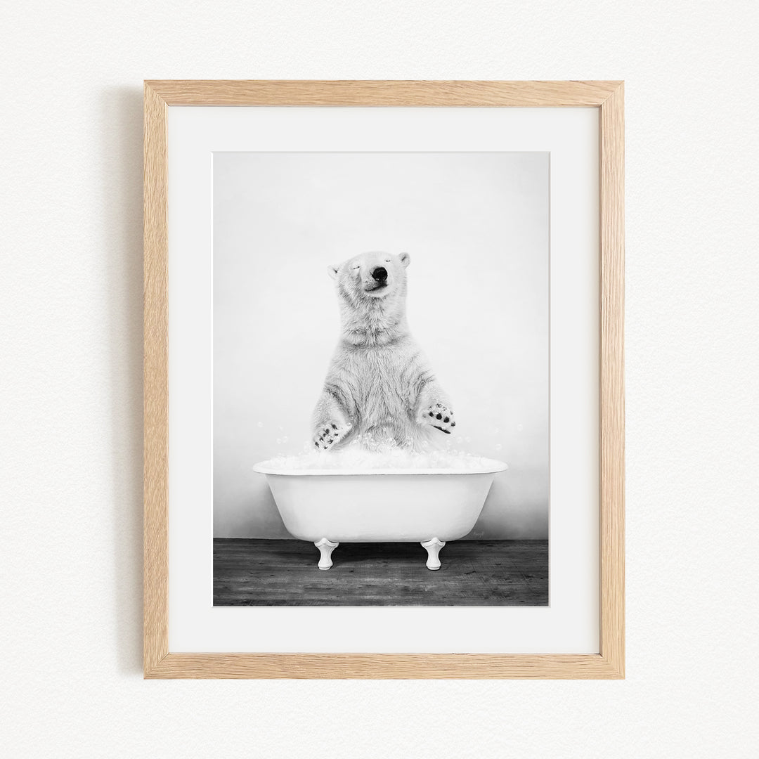 A polar bear standing in a bathtub filled with water, appearing to be enjoying a bath.