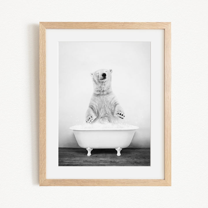 A polar bear standing in a bathtub filled with water, appearing to be enjoying a bath.