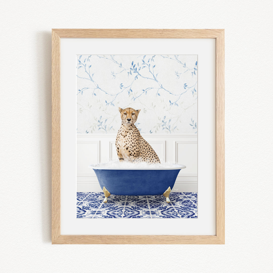 A cheetah sitting in a blue bathtub filled with water, surrounded by a blue and white patterned rug.