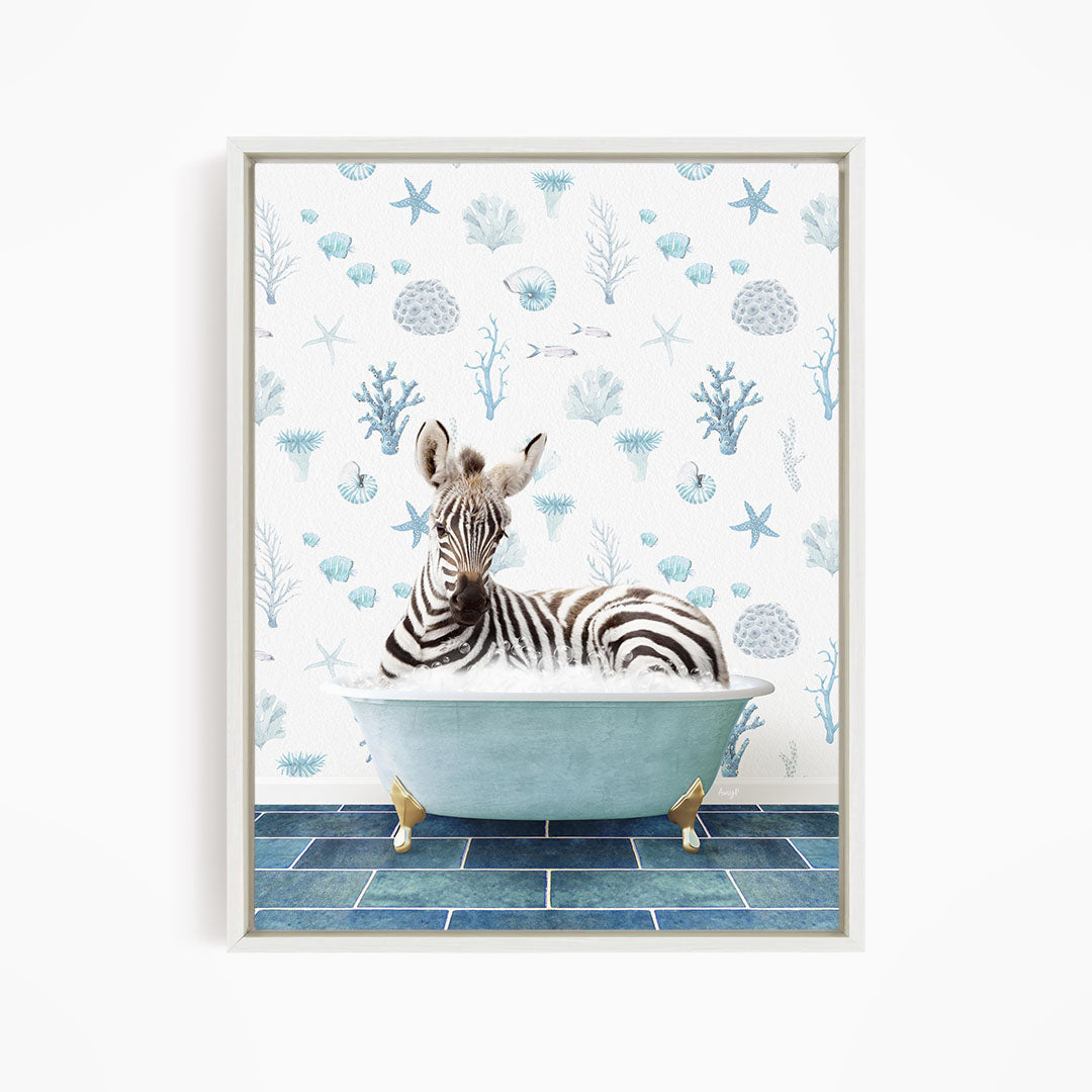 A zebra is sitting in a blue bathtub, surrounded by a pattern of seashells and starfish on the wall behind it.