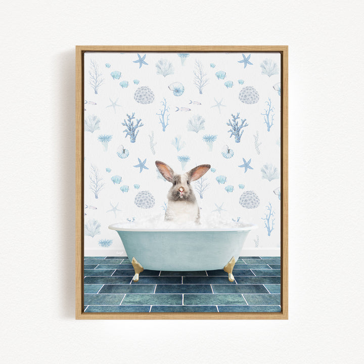 A rabbit sitting in a bathtub filled with bubbles, surrounded by a blue and white ocean-themed wallpaper.